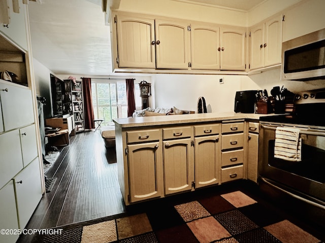 2703 David St, Juneau, AK 99801 - kitchen with appliances with stainless steel finishes, a peninsula, light countertops, and dark wood-type flooring