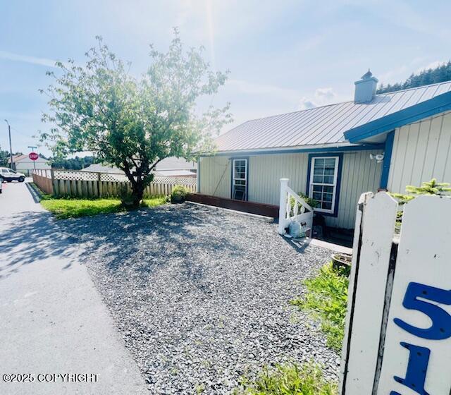515 Maple Ave, Kodiak, AK 99615 - view of property exterior with a metal roof, a chimney, and a standing seam roof