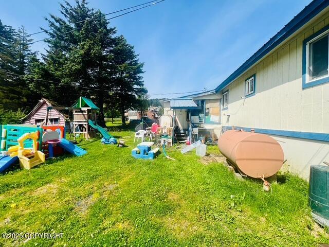 515 Maple Ave, Kodiak, AK 99615 - view of green lawn featuring a playground