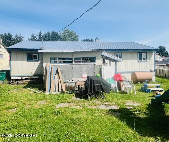 515 Maple Ave, Kodiak, AK 99615 - back of property featuring heating fuel, a metal roof, and a yard
