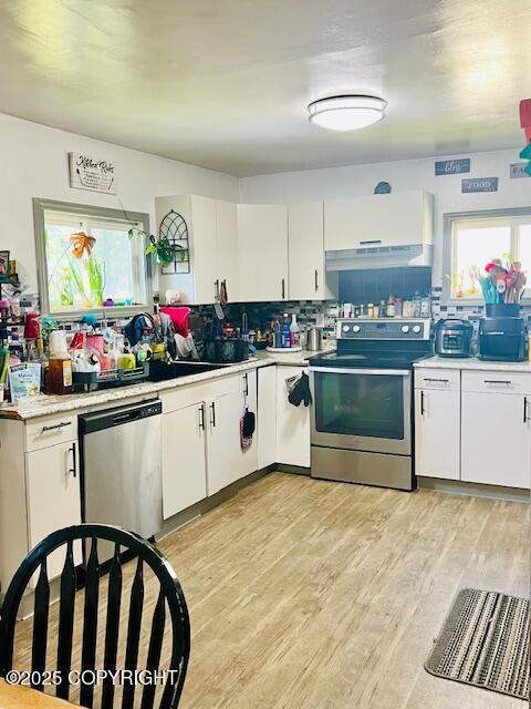 515 Maple Ave, Kodiak, AK 99615 - kitchen featuring stainless steel appliances, light countertops, white cabinets, and under cabinet range hood