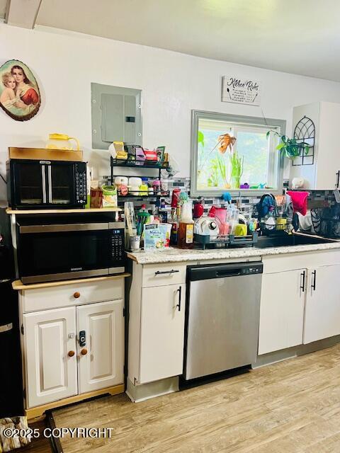 515 Maple Ave, Kodiak, AK 99615 - kitchen with appliances with stainless steel finishes, electric panel, white cabinetry, light wood-type flooring, and light countertops
