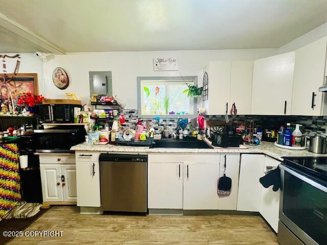 515 Maple Ave, Kodiak, AK 99615 - kitchen with appliances with stainless steel finishes, white cabinetry, light countertops, and light wood-style floors