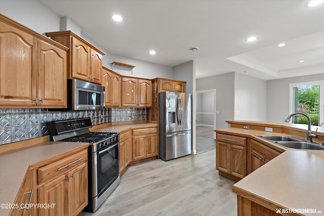 3827 E Country Field Cir, Wasilla, AK 99654 - kitchen featuring stainless steel appliances, light wood-style flooring, tasteful backsplash, recessed lighting, and light countertops