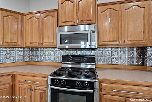 3827 E Country Field Cir, Wasilla, AK 99654 - kitchen with appliances with stainless steel finishes, light countertops, and backsplash