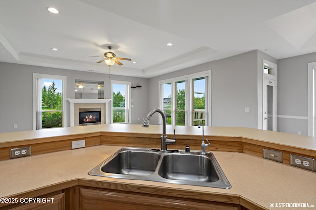 3827 E Country Field Cir, Wasilla, AK 99654 - kitchen featuring a raised ceiling, a ceiling fan, light countertops, recessed lighting, and open floor plan
