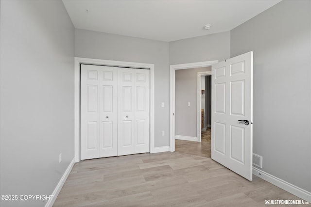 3827 E Country Field Cir, Wasilla, AK 99654 - unfurnished bedroom with light wood-type flooring and a closet