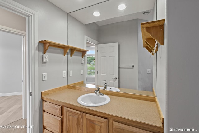 3827 E Country Field Cir, Wasilla, AK 99654 - bathroom with vanity, wood finished floors, and recessed lighting