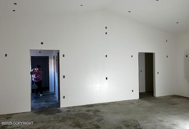 21635 Renault St, Kasilof, AK 99610 - empty room with high vaulted ceiling and unfinished concrete flooring