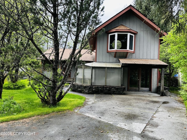9238 Emily Way, Juneau, AK 99801 - view of front of property featuring french doors, board and batten siding, and driveway