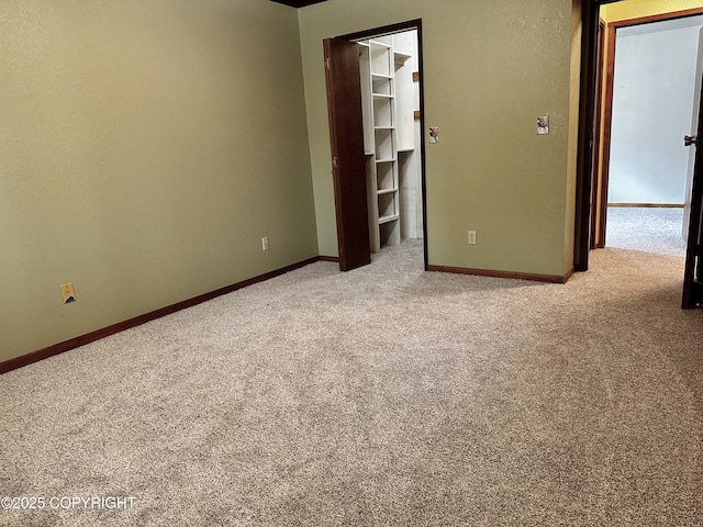 9238 Emily Way, Juneau, AK 99801 - unfurnished bedroom with carpet flooring, a walk in closet, and a closet