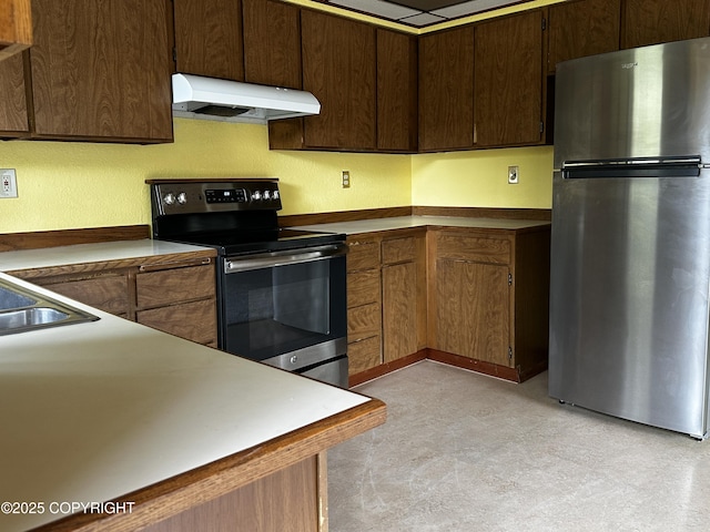 9238 Emily Way, Juneau, AK 99801 - kitchen with appliances with stainless steel finishes, premium range hood, light floors, and dark brown cabinets