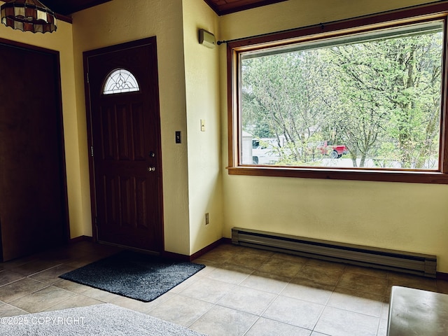9238 Emily Way, Juneau, AK 99801 - foyer entrance with a baseboard heating unit, light tile patterned flooring, and a textured wall