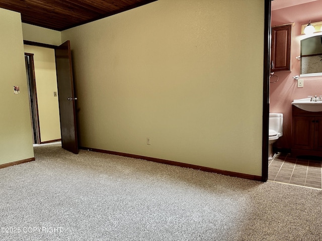 9238 Emily Way, Juneau, AK 99801 - unfurnished bedroom featuring light carpet, wooden ceiling, and connected bathroom