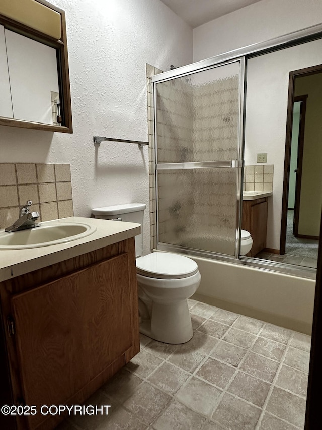 9238 Emily Way, Juneau, AK 99801 - full bath with vanity, enclosed tub / shower combo, stone finish flooring, and a textured wall