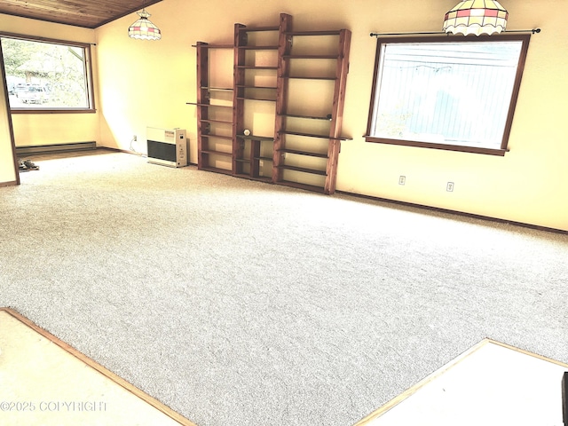 9238 Emily Way, Juneau, AK 99801 - unfurnished living room with carpet floors, a baseboard heating unit, and lofted ceiling