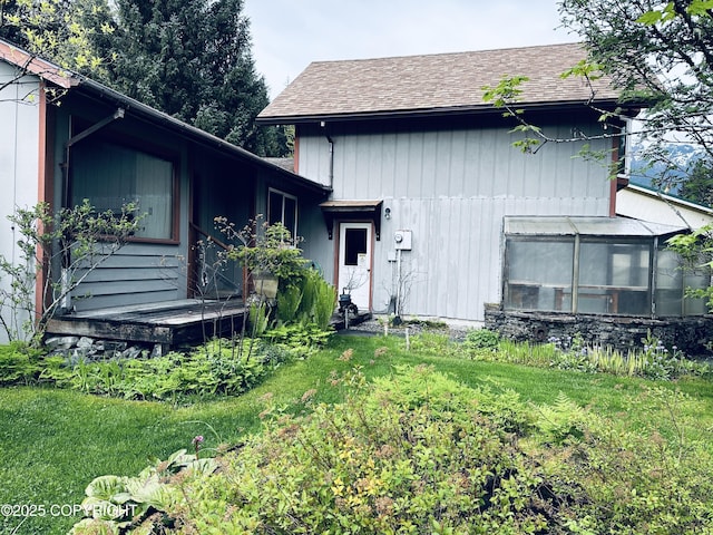 9238 Emily Way, Juneau, AK 99801 - rear view of house with roof with shingles and a greenhouse