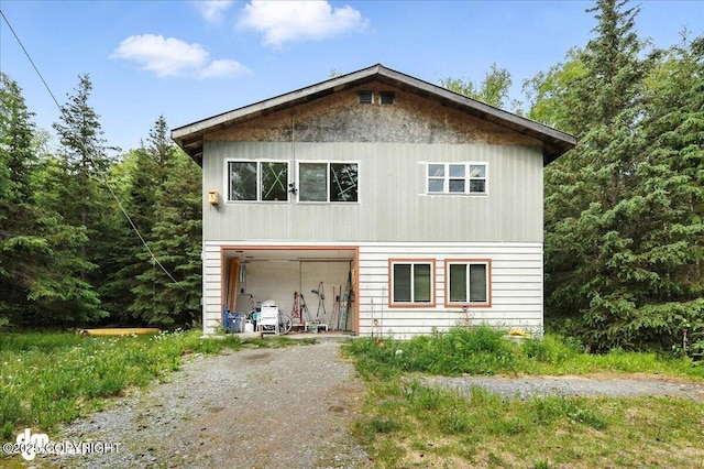 63735 Caribou Ln, Hope, AK 99605 - view of front of house with dirt driveway and a garage