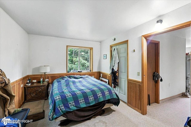 63735 Caribou Ln, Hope, AK 99605 - carpeted bedroom with wainscoting, wooden walls, and a closet