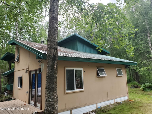 22120 S Easy St, Talkeetna, AK 99676 - view of home's exterior featuring a metal roof, stucco siding, and a deck
