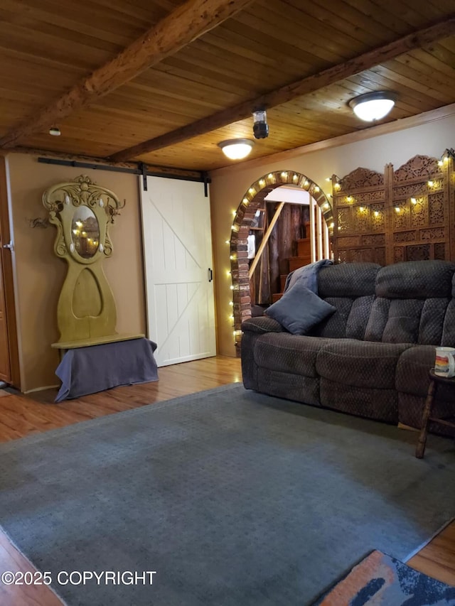 22120 S Easy St, Talkeetna, AK 99676 - living area featuring a wood ceiling with exposed beams, arched walkways, wood finished floors, and a barn door