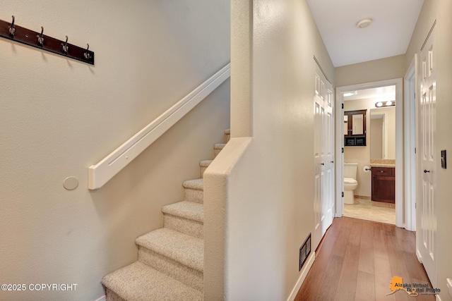 7612 Lumbis Ave # 4, Anchorage, AK 99518 - staircase featuring wood-type flooring