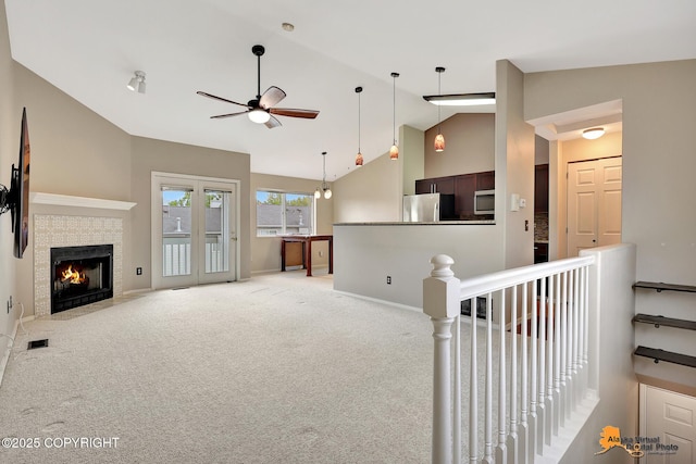 7612 Lumbis Ave # 4, Anchorage, AK 99518 - living area with a ceiling fan, carpet floors, a tiled fireplace, and high vaulted ceiling