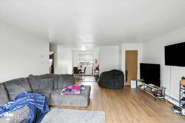 330 N Bliss St, Anchorage, AK 99508 - living area with wood finished floors and a baseboard radiator