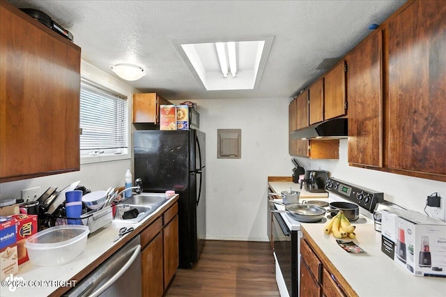 330 N Bliss St, Anchorage, AK 99508 - kitchen with electric stove, under cabinet range hood, freestanding refrigerator, dark wood-style flooring, and light countertops