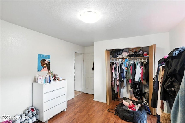 330 N Bliss St, Anchorage, AK 99508 - bedroom featuring wood finished floors, a closet, and a textured ceiling