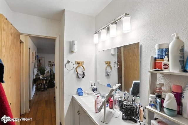 330 N Bliss St, Anchorage, AK 99508 - bathroom with vanity, wood finished floors, and a textured wall