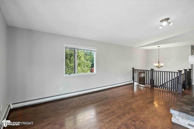 18723 N Lowrie Loop, Eagle River, AK 99577 - spare room featuring a chandelier, baseboard heating, wood finished floors, and vaulted ceiling