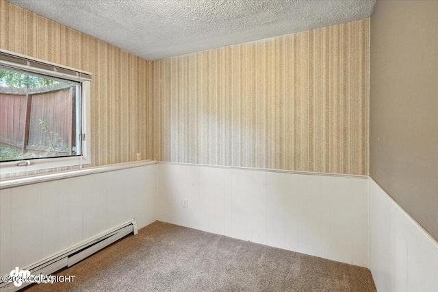 18723 N Lowrie Loop, Eagle River, AK 99577 - unfurnished room featuring a baseboard radiator, wainscoting, wallpapered walls, a textured ceiling, and carpet