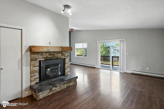 18723 N Lowrie Loop, Eagle River, AK 99577 - unfurnished living room featuring a baseboard radiator, lofted ceiling, wood finished floors, a fireplace, and a textured ceiling
