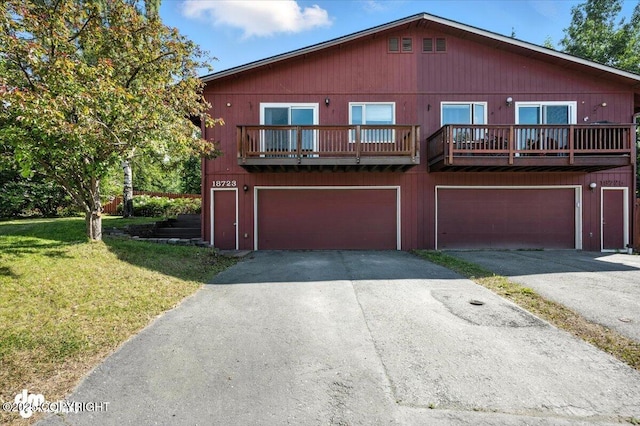 18723 N Lowrie Loop, Eagle River, AK 99577 - view of front of property featuring asphalt driveway, a front yard, and a garage