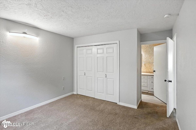 18723 N Lowrie Loop, Eagle River, AK 99577 - unfurnished bedroom featuring carpet, a textured ceiling, and a closet