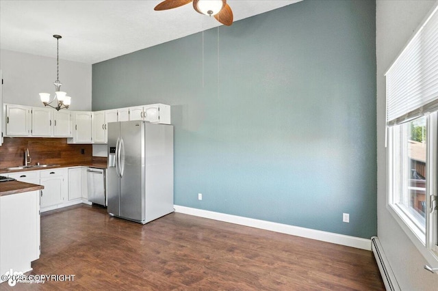 18723 N Lowrie Loop, Eagle River, AK 99577 - kitchen with appliances with stainless steel finishes, a baseboard radiator, a chandelier, dark countertops, and a ceiling fan