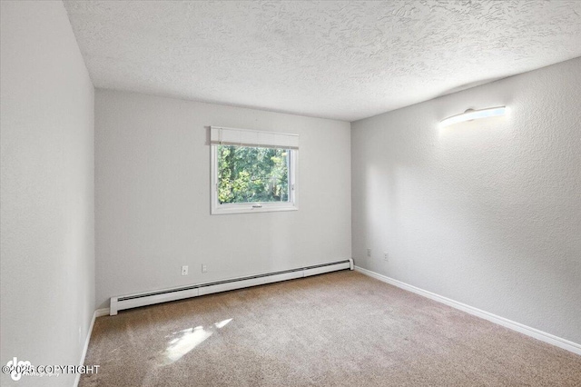 18723 N Lowrie Loop, Eagle River, AK 99577 - carpeted empty room featuring a baseboard heating unit, a textured ceiling, and a textured wall