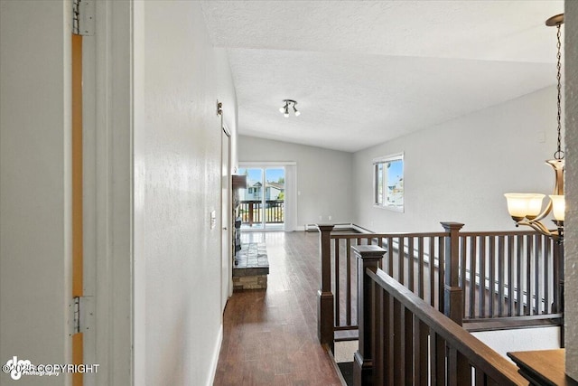 18723 N Lowrie Loop, Eagle River, AK 99577 - corridor featuring an upstairs landing, lofted ceiling, a textured ceiling, dark wood finished floors, and a chandelier