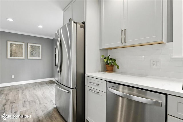 12220 Shiloh Rd, Anchorage, AK 99516 - kitchen featuring stainless steel appliances, ornamental molding, decorative backsplash, light wood finished floors, and light stone countertops