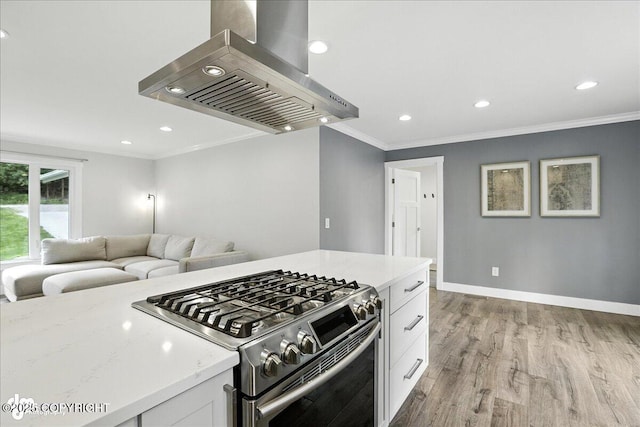 12220 Shiloh Rd, Anchorage, AK 99516 - kitchen featuring extractor fan, stainless steel range with gas stovetop, crown molding, white cabinetry, and light wood-style floors