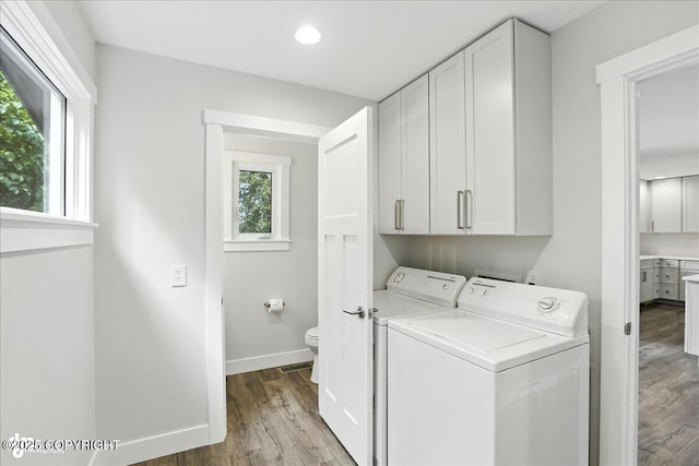 12220 Shiloh Rd, Anchorage, AK 99516 - laundry area featuring independent washer and dryer, wood finished floors, cabinet space, and recessed lighting