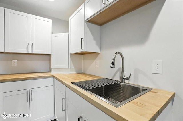 12220 Shiloh Rd, Anchorage, AK 99516 - kitchen with wooden counters and white cabinetry