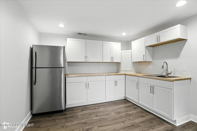 12220 Shiloh Rd, Anchorage, AK 99516 - kitchen featuring freestanding refrigerator, white cabinets, dark wood-type flooring, and recessed lighting