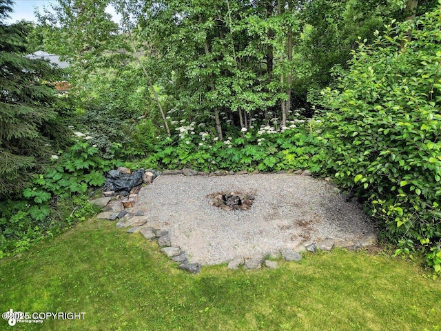 12220 Shiloh Rd, Anchorage, AK 99516 - view of green lawn with an outdoor fire pit