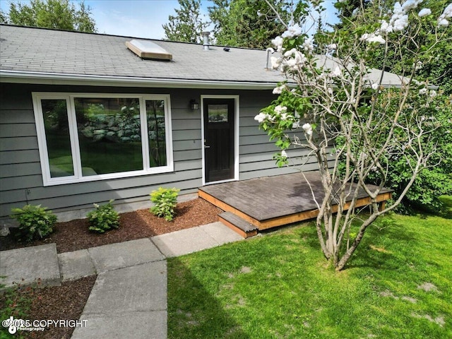 12220 Shiloh Rd, Anchorage, AK 99516 - view of front of house with a deck, a front lawn, and a shingled roof