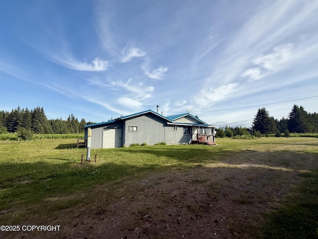 24220 Sterling Hwy, Ninilchik, AK 99639 - view of side of property featuring a yard and a garage