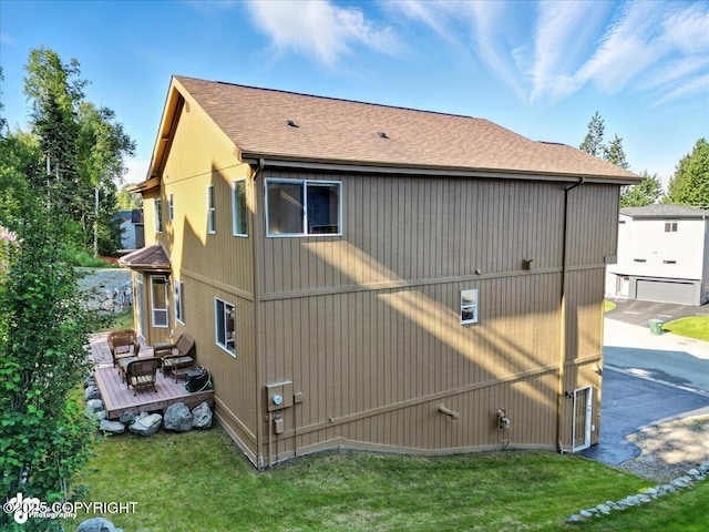 1677 Circlewood Dr, Anchorage, AK 99516 - view of home's exterior featuring a deck, a shingled roof, and a yard