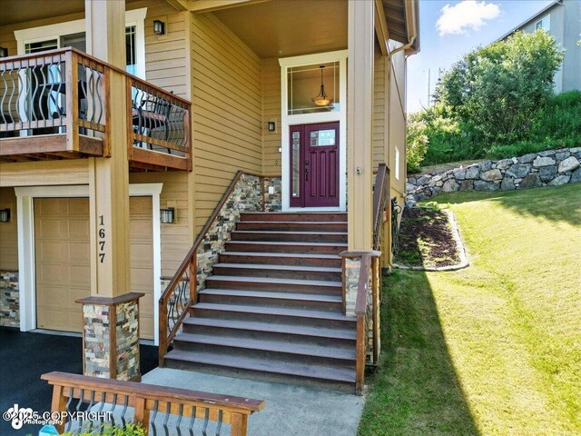1677 Circlewood Dr, Anchorage, AK 99516 - property entrance featuring an attached garage, a balcony, and a yard