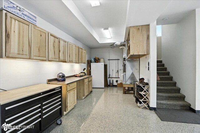 1677 Circlewood Dr, Anchorage, AK 99516 - basement featuring freestanding refrigerator and stairway